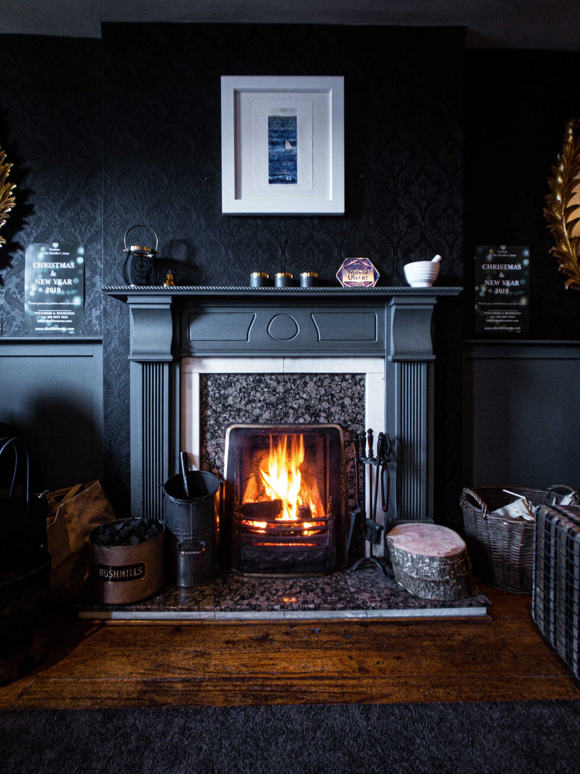 Roaring fire in a dark grey fire surround.
