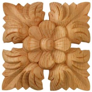 Square pine wood carved applique with central flower and a leaf in each of the four corners.