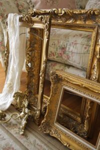 Four ornate gold picture frames.