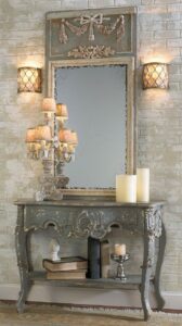 Console table with mirror above it. Both have painted wood carved appliques in grey and gold.